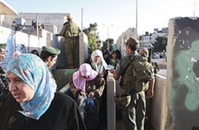 Border policeman checks Palestinians 248 (photo credit: )