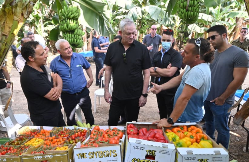Defense Minister Benny Gantz speaking to the local farmers in the south of Israel, August 3, 2021 (photo credit: ARIEL HERMONI / DEFENSE MINISTRY)