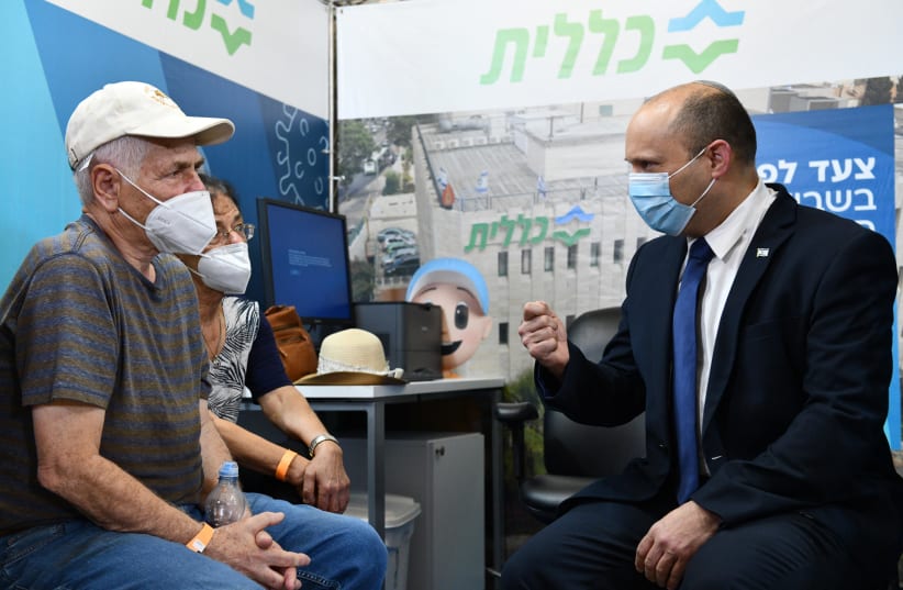 Prime Minister Naftali Bennett inaugurating the new vaccination center for Clalit Health Services in Jerusalem's Cinema City, August 8, 2021.  (photo credit: CHAIM TZACH/GPO)