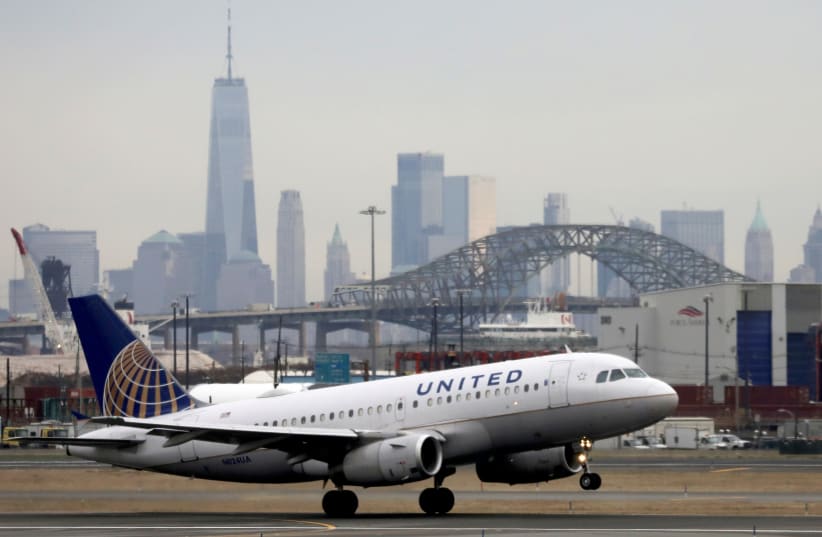   A United Airlines passenger jet takes off with New York City as a backdrop, at Newark Liberty International Airport, New Jersey, US December 6, 2019. (photo credit: REUTERS/CHRIS HELGREN)