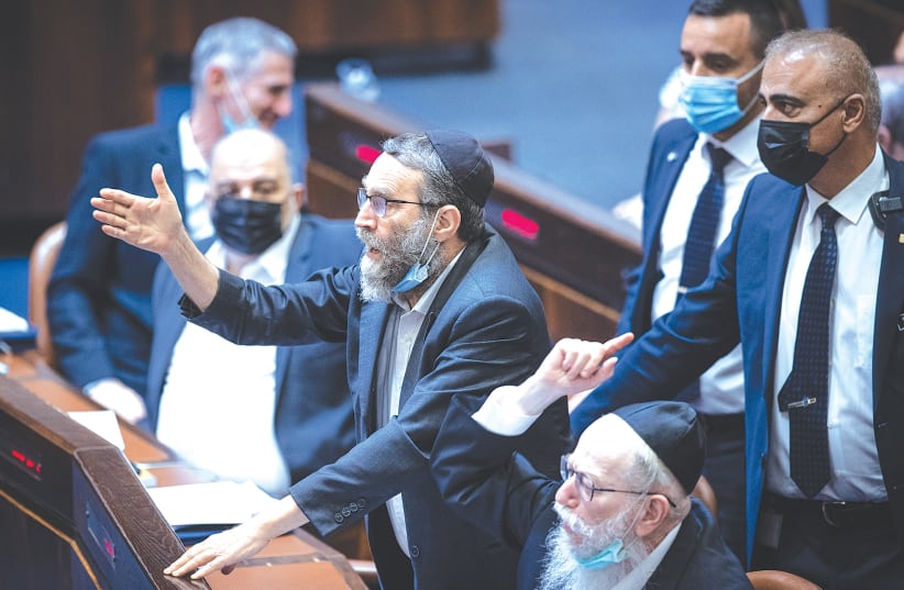 MK MOSHE GAFNI is removed from the Knesset plenum by a security guard earlier this week. (photo credit: YONATAN SINDEL/FLASH90)