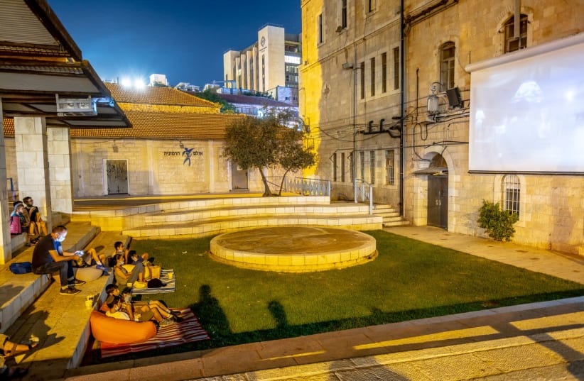 Jerusalem residents watch a film in Kikar HaYareach as part of the Moonlight Cinema project organised by the Jerusalem Municipality   (photo credit: HODAYA TOLEDANO)
