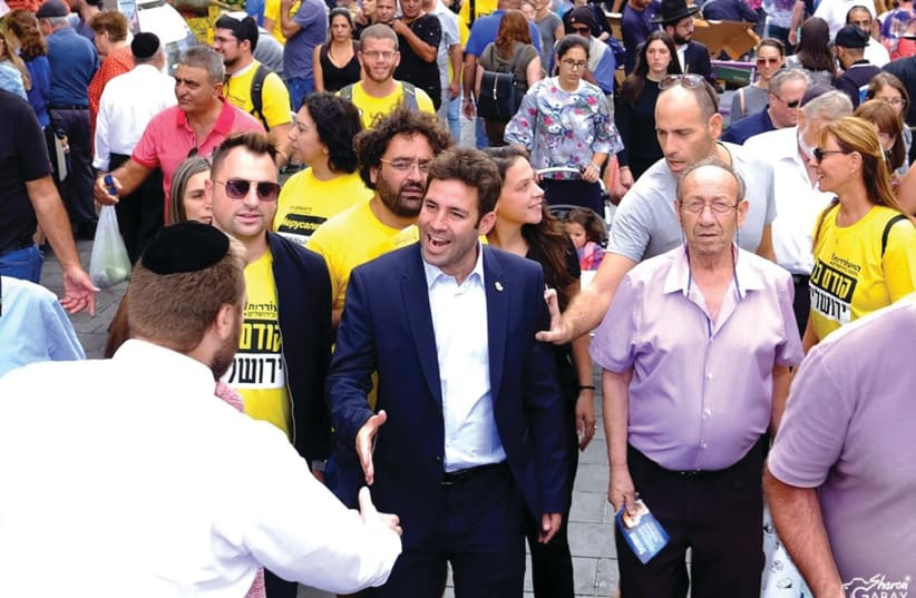 OFER BERKOVITCH campaigns in the last mayoral election, with members of his Hitoreut faction (in bright yellow T-shirts). (photo credit: Courtesy Ofer Berkovitch)