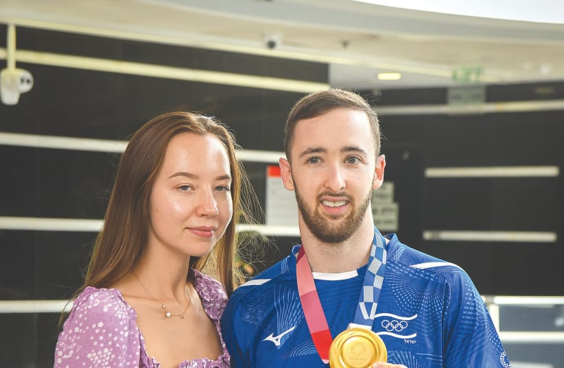  ARTEM DOLGOPYAT and Masha Sakovich pose for a photo during a homecoming ceremony for the gold medal winner in Rishon Lezion on Tuesday. (photo credit: FLASH90)
