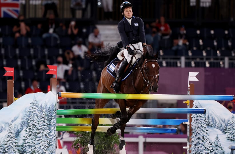 Teddy Vlock of Israel on his horse Amsterdam 27 competes at the jumping team qualifications, August 6, 2021. (photo credit: REUTERS/ALKIS KONSTANTINIDIS)