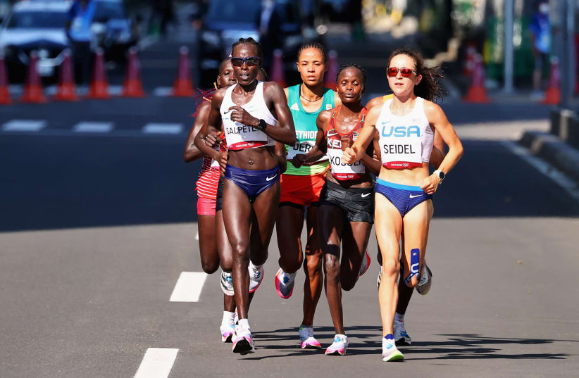 Tokyo 2020 Olympics - Athletics - Women's Marathon - Sapporo Odori Park, Sapporo, Japan - August 7, 2021. Molly Seidel of the United States and Lonah Chemtai Salpeter of Israel in action  (photo credit: REUTERS/KIM HONG-JI)