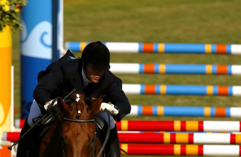 GERMANY'S Kim Raisner riding 'Celago' at the 2004 Athens Olympics (photo credit: REUTERS/RICHARD HEATHCOTE)