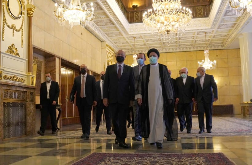 Iraq's President Barham Salih walks with Iran's new President Ebrahim Raisi during a meeting in Tehran (photo credit: REUTERS)
