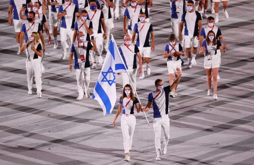 HANNA MINENKO and Yaakov Toumarkin lead the Israeli delegation of athletes at the opening of the Tokyo Olympics, in which the country captured four medals. (photo credit: REUTERS)