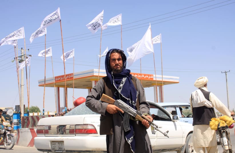 A Taliban fighter looks on as he stands at the city of Ghazni, Afghanistan August 14, 2021. (photo credit: STRINGER/ REUTERS)