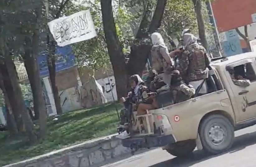  Taliban waving a flag drive through the streets of Kabul, Afghanistan August 16, 2021 in this still image taken from social media video.  (photo credit: SNAPCHAT/ @ mr_khaludi /VIA REUTERS)