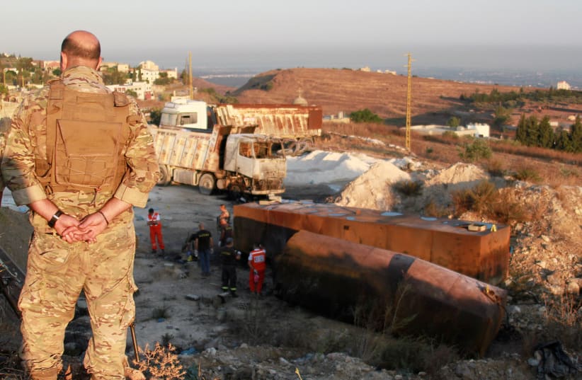  A Lebanese army soldier stands guard near the site of a fuel tank explosion in Akkar, in northern Lebanon (photo credit: OMAR IBRAHIM / REUTERS)