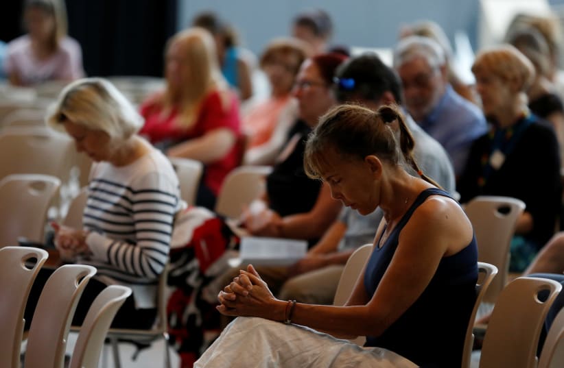  Worshipers are seen during a service at Christ Church United Methodist Church as names of victims of the school shooting were read in Fort Lauderdale (photo credit: JOE SKIPPER/REUTERS)