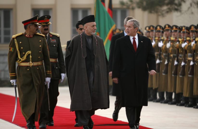 President George W. Bush and Afghan President Hamid Karzai review a honor guard at the Presidential Palace in Kabul December 15, 2008.  (photo credit: REUTERS/KEVIN LAMARQUE)