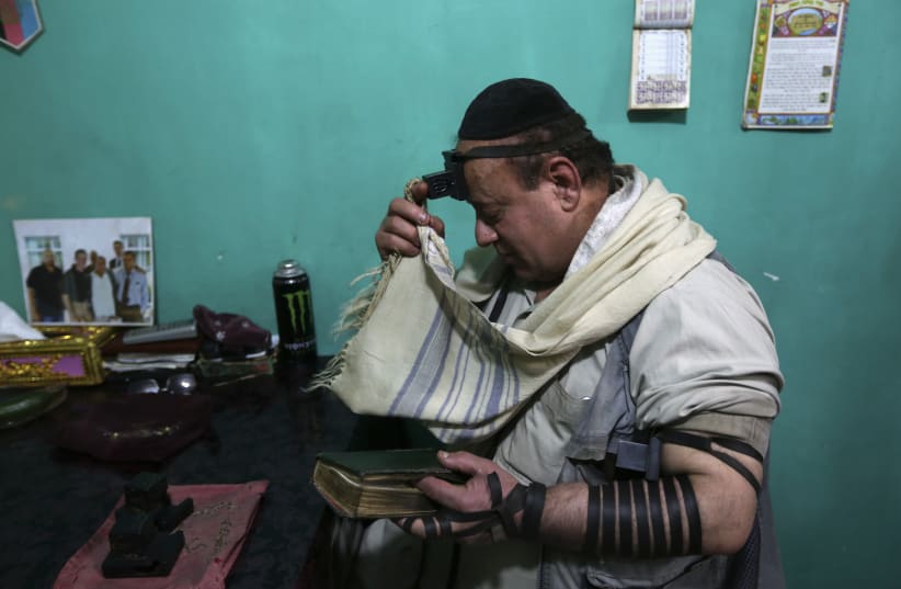   Simantov, an Afghan Jew, prays at his residence in Kabul (photo credit: REUTERS)