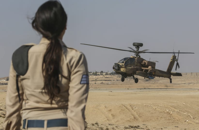  An Israeli Air Force soldier looks on at an Apache helicopters belonging to the Israeli Air Force 113 Squadron Unit (also known as the Hornet Squadron Unit) at an airforce base in Southern Israel. The unit was formed on October 4, 1955. The Hornets were the first squadron to fly 24 MD450B Dassault  (photo credit: NATI SHOHAT/FLASH90)