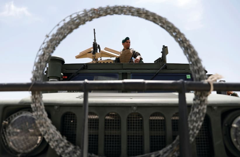 An Afghan security forces member keeps watch at Bagram US air base in Parwan province after American troops vacated it in July. (photo credit: MOHAMMAD ISMAIL/REUTERS)