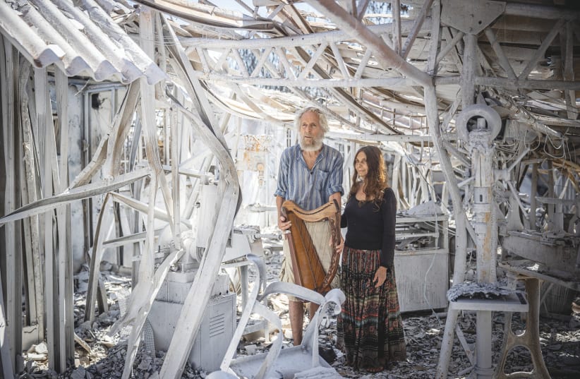  SHOSHANNA AND MICHAH Harrari look at their burned down factory that manufactures handmade King David Biblical Harps, in Moshav Ramat Raziel, on Wednesday. (photo credit: YONATAN SINDEL/FLASH90)