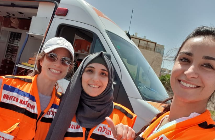 Three women EMT volunteers of United Hatzalah after finishing an ambulance shift in Jerusalem, one haredi, one religious Muslim, and one secular. (photo credit: UNITED HATZALAH‏)