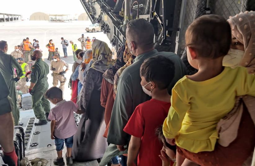  Evacuees from Afghanistan disembark a Spanish military plane as part of their evacuation at Al Maktoum International Airport (DWC) in Dubai, United Arab Emirates, August 20, 2021. (photo credit: REUTERS)