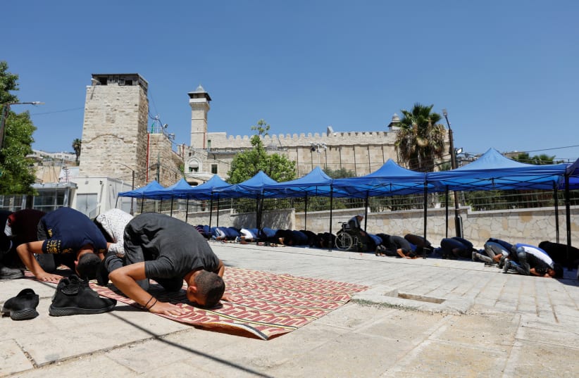 Palestinians attend Friday prayers in Hebron near the Tomb of the Patriarchs, August 20, 2021  (photo credit: REUTERS/MUSSA QAWASMA)