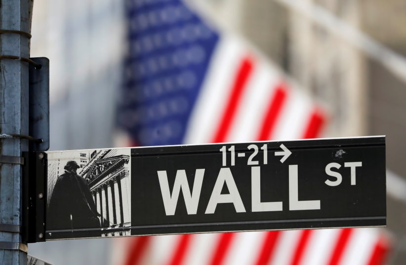  A street sign for Wall Street is seen outside the New York Stock Exchange (NYSE) in New York City, New York, US, July 19, 2021. (photo credit: REUTERS/ANDREW KELLY/FILE PHOTO)