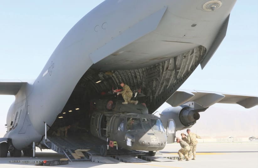  A UH-60L Blackhawk helicopter is loaded into a US Air Force C-17 Globemaster III during the withdrawal of forces in Afghanistan, in June. (photo credit: SGT. 1ST CLASS COREY VANDIVER/US ARMY/REUTERS)