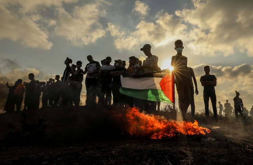  Palestinian protesters clash with Israeli forces during a protest at the Israel-Gaza border, east of Gaza City, on August 21, 2021.  (photo credit: ABED RAHIM KHATIB/FLASH90)