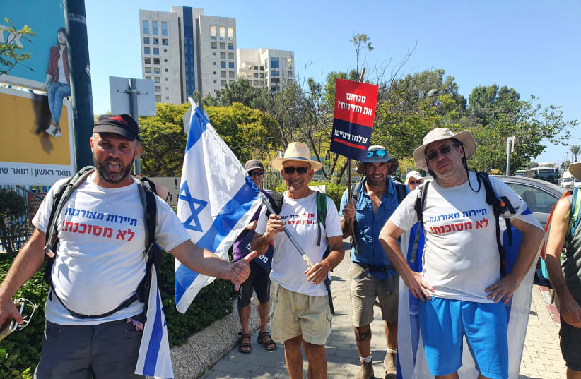  Tour guides protest closures on a march from Caesaria to Jerusalem, August 24, 2021. (photo credit: WAI LAM CHAN)