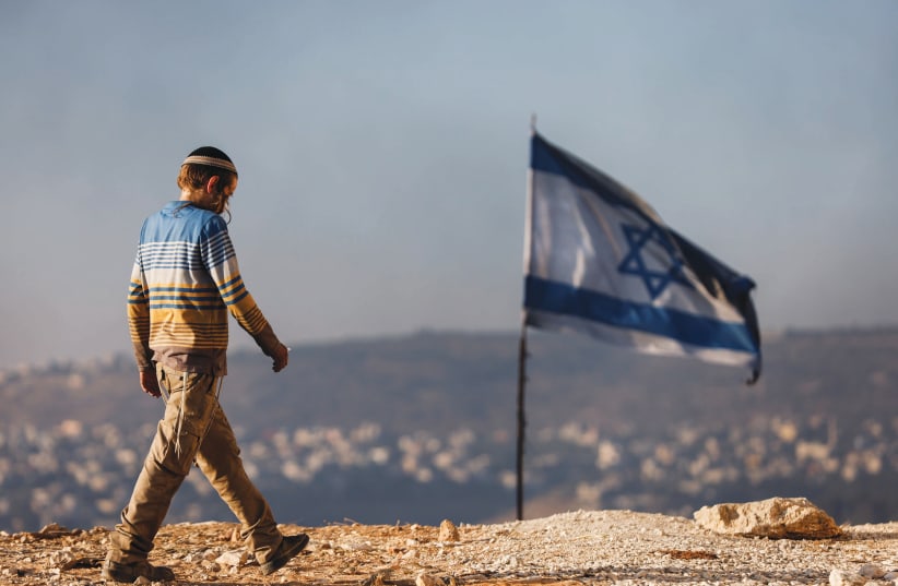  A JEWISH teenager in Givat Evyatar, near the Palestinian village of Beita. (photo credit: AMIR COHEN/REUTERS)