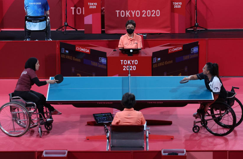  Caroline Tabib of Israel and Khetam Abu Awad of Jordan in action - Tokyo 2020 Paralympic Games - Table Tennis (photo credit: IVAN ALVARADO/REUTERS)