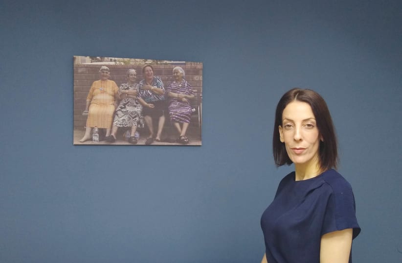  Mayor Tal Ohana in her municipality office with the photo of the four Yeroham grandmothers (photo credit: ANAV SILVERMAN PERETZ)