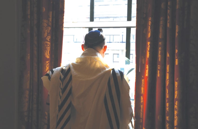  Prime Minister Naftali Bennett praying at the Willard Hotel in Washington on Wednesday. (photo credit: AVI OHAYON - GPO)