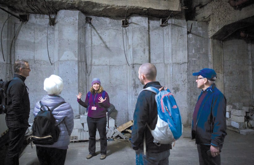  Tour guide Gila leads a group in the 'bat cave' of Tel Aviv's Central Bus Station (photo credit: MIRIAM ALSTER/FLASH90)