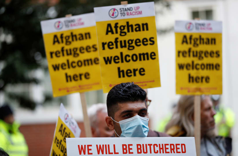  Demonstrators take part in a protest, called jointly by Stand Up To Racism and the Afghan Human Rights Foundation, in support of refugees from Afghanistan, in London, Britain August 23, 2021. (photo credit: REUTERS/PETER NICHOLLS)