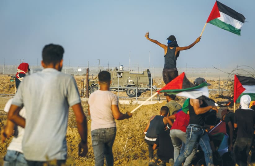  PALESTINIAN PROTESTERS clash with IDF forces during at the Israel-Gaza border east of Khan Yunis last week.  (photo credit: ABED RAHIM KHATIB/FLASH90)