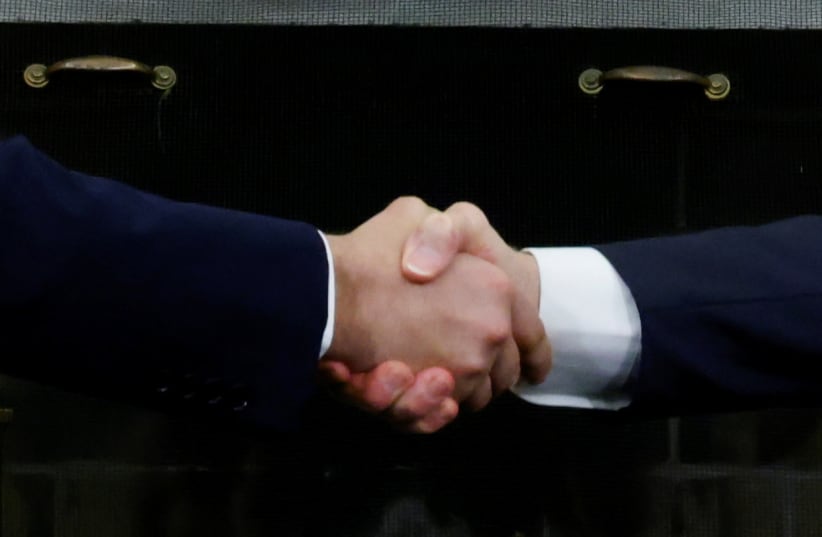 US President Joe Biden and Israel's Prime Minister Naftali Bennett shake hands during a meeting in the Oval Office at the White House in Washington, US Augus 7, 2021.  (photo credit: REUTERS/JONATHAN ERNST)