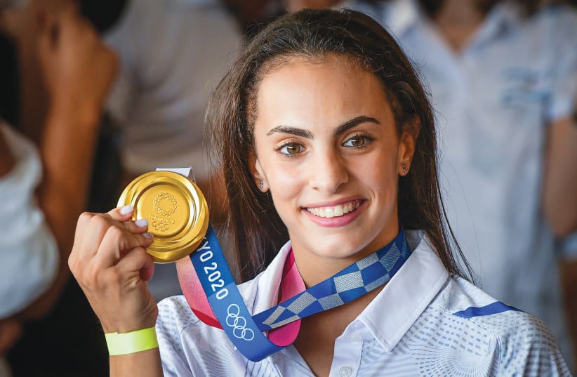  OLYMPIC GOLD medalist Linoy Ashram is greeted by family and friends as she arrives at Ben-Gurion Airport earlier this month (photo credit: AVSHALOM SASSONI/FLASH90)