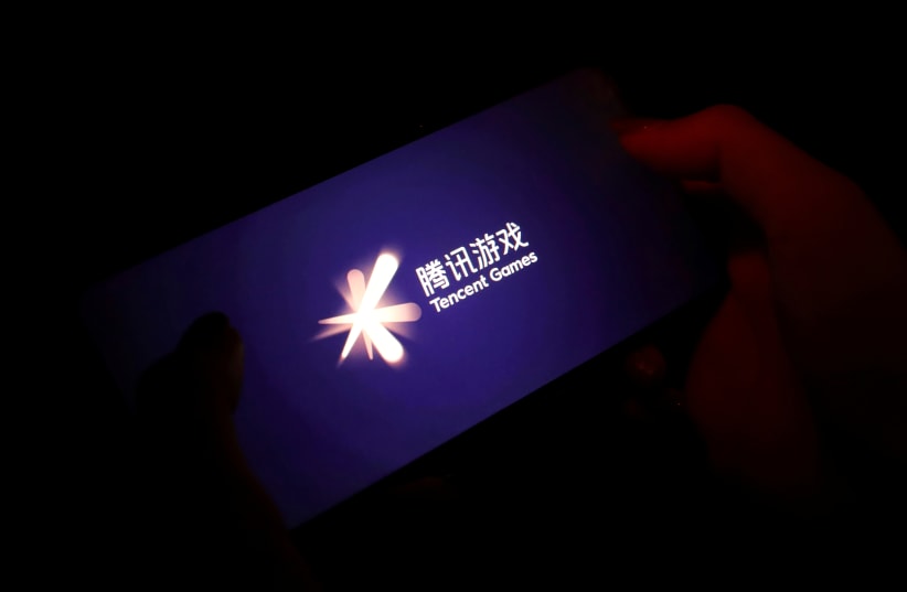 The Tencent Games logo is seen on its game on a mobile phone in this illustration picture taken August 3, 2021. (photo credit: REUTERS/FLORENCE LO/ILLUSTRATION/FILE PHOTO)