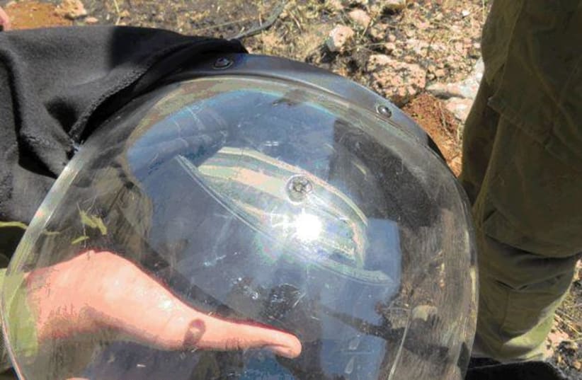An IDF soldier's helmet is seen with a mark where an M-16 bullet impacted. (photo credit: Courtesy Shin Bet)