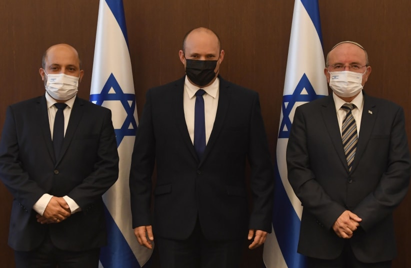  (L-R) Incoming NSC head Dr. Eyal Hulata, Prime Minister Naftali Bennett and retired NSC head Meir Ben-Shabbat posing at the Prime Minister's Office in Jerusalem. (photo credit: CHAIM TZACH/GPO)