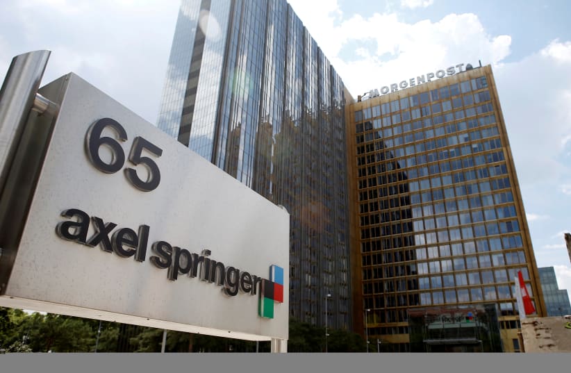  The logo of German publisher Axel Springer is pictured in front of the company's headquarters in Berlin July 25, 2013. (photo credit: REUTERS/FABRIZIO BENSCH)