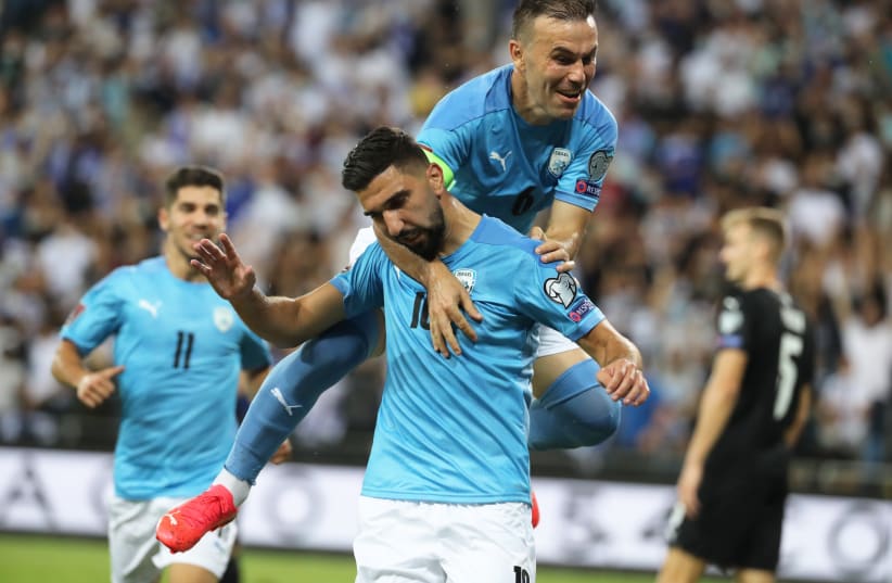  Israel's Munas Dabbur celebrates scoring Israel's second goal of the game with Bibras Natcho. (photo credit: REUTERS/AMMAR AWAD)