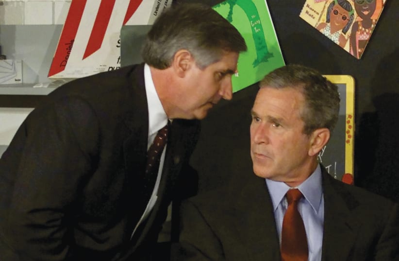  US PRESIDENT George W. Bush is  informed of a second plane hitting the  World Trade Center by White House  chief of staff Andrew Card, at an  elementary school in Sarasota, Florida,  on September 11, 2001. (photo credit: WIN MCNAMEE/REUTERS)