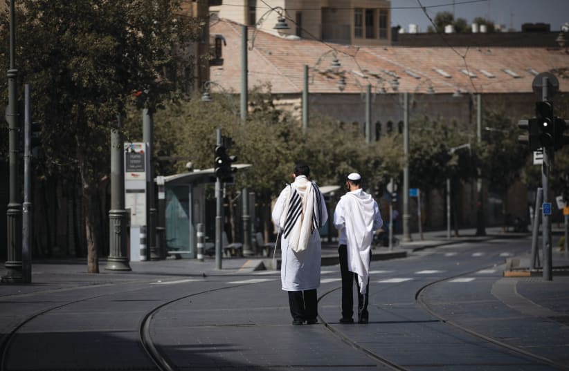  ABSOLUTE QUIET: Walking the  empty streets on Yom Kippur.  (photo credit: YONATAN SINDEL/FLASH90)
