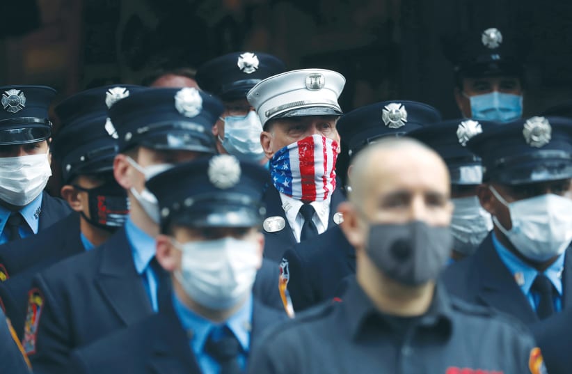  NEW YORK CITY Fire Department firefighters stand in formation on the anniversary last year of the 9/11 attacks. (photo credit: SHANNON STAPLETON / REUTERS)