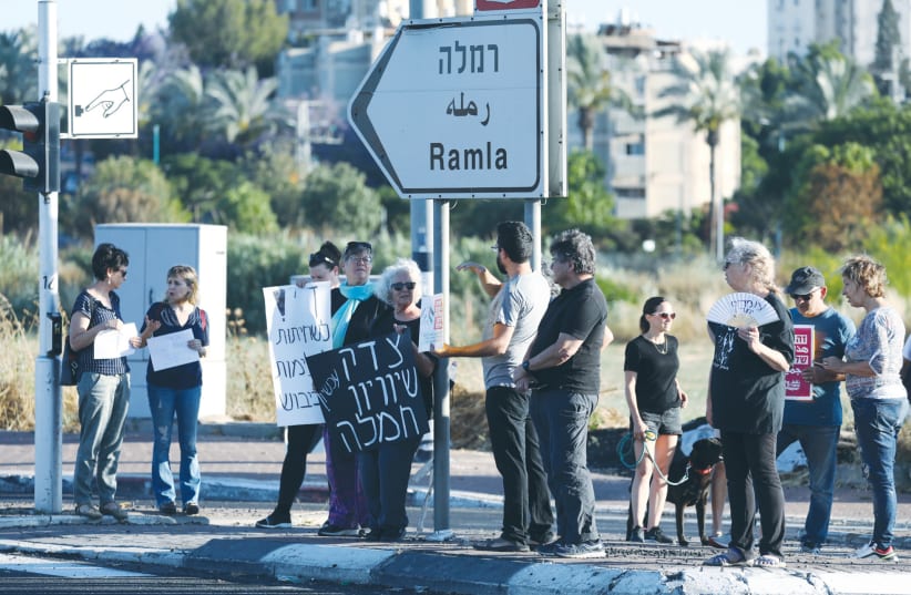  JEWS AND MUSLIMS protest together for calm and coexistence in Lod, following a night of heavy rioting by Arab residents in the city, in May. (photo credit: YOSSI ALONI/FLASH90)