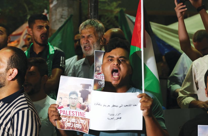  PALESTINIANS IN HEBRON demonstrate in support of the six escaped Palestinian prisoners, on Wednesday. (photo credit: WISAM HASHLAMOUN/FLASH90)