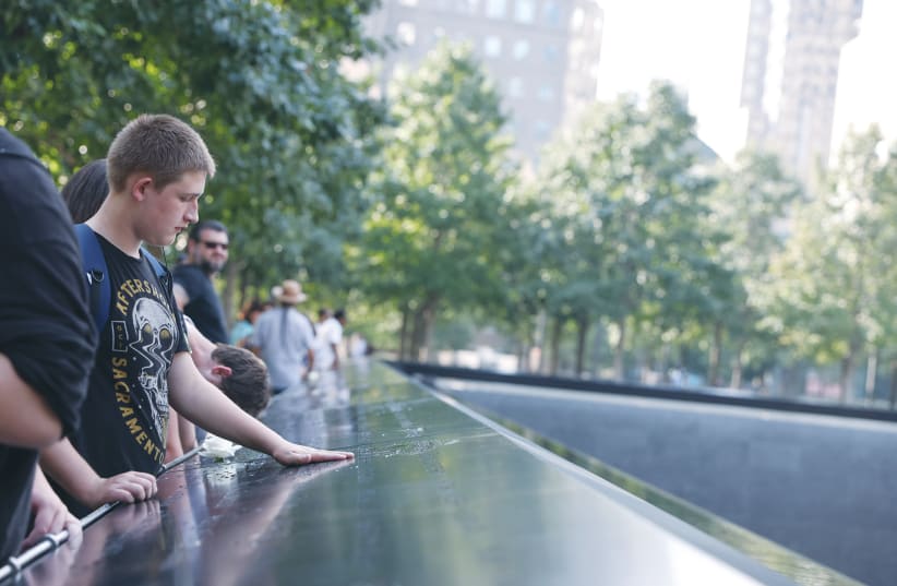  TUDENT PRESTON Lovelady takes in the South Pool of the 9/11 Memorial after touring the 9/11 Tribute Museum in New York City, last month.  (photo credit: CAITLIN OCHS/REUTERS)