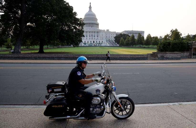 US Capitol Police officer patrols around the US Capitol in Washington, DC (photo credit: REUTERS)